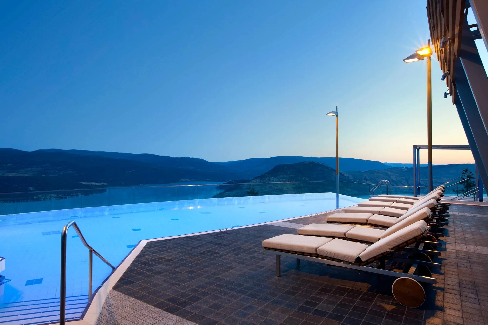 Sparkling Hill heated infinity pool overlooking Okanagan Lake at dusk